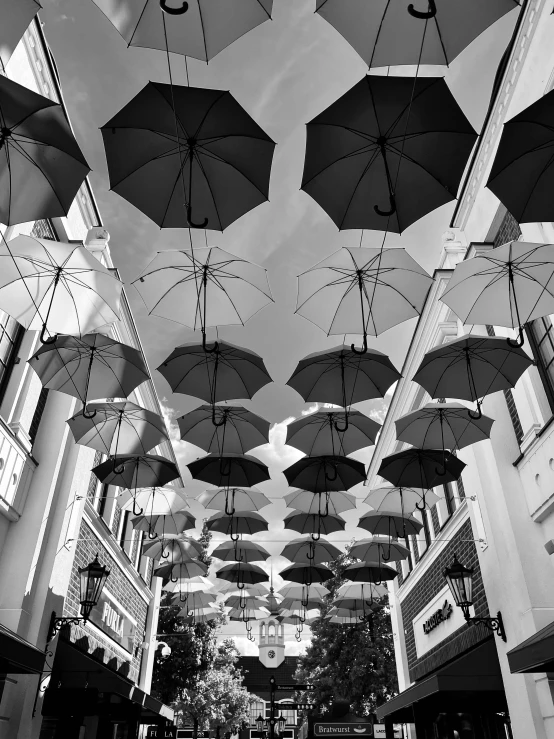 a long hallway that has several open umbrellas over the top