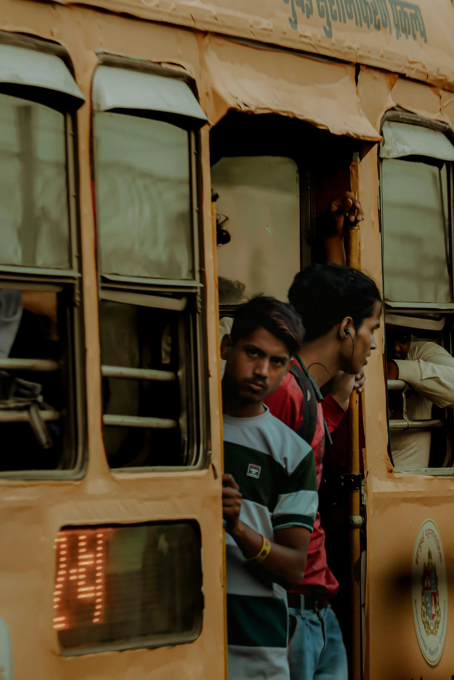 people are standing inside of a yellow bus