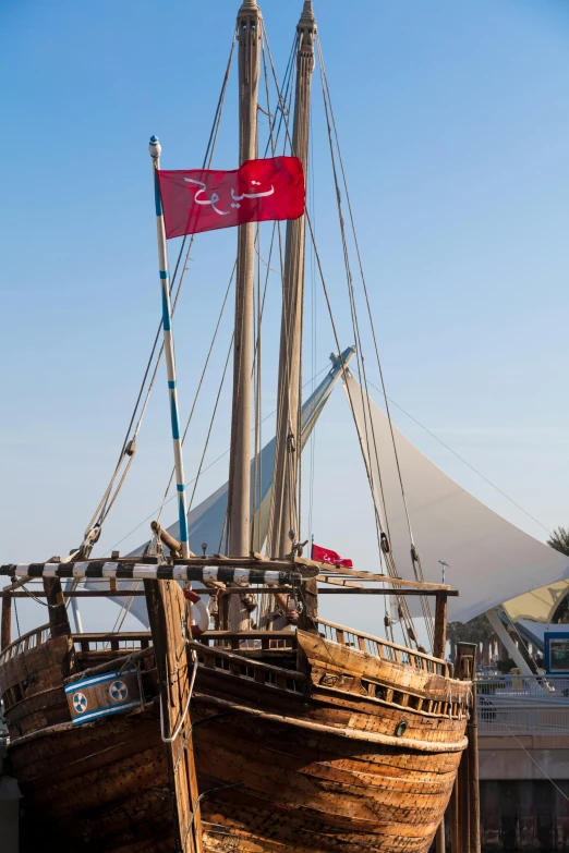 an old sailboat with a banner flying on it