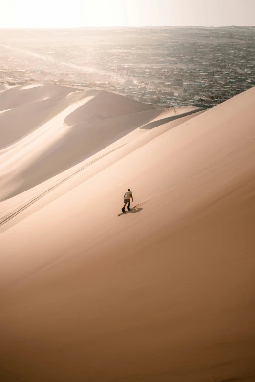 a man hiking across a very large sandy field