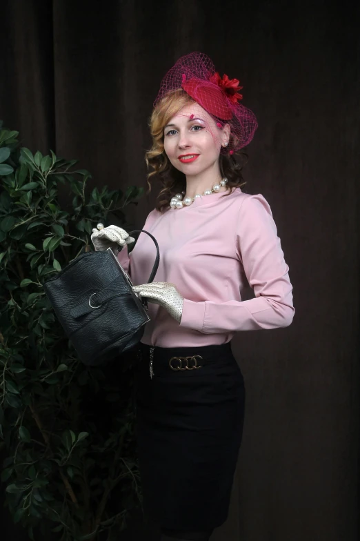 a woman wearing a pink hat and holding a handbag