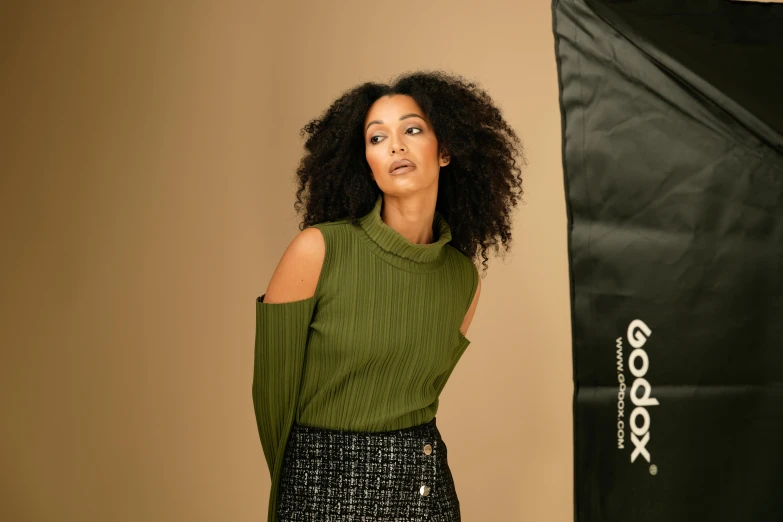 woman with afro standing in front of a pography light