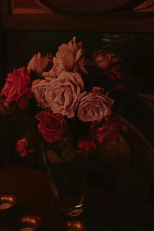 a vase full of dried roses on a table