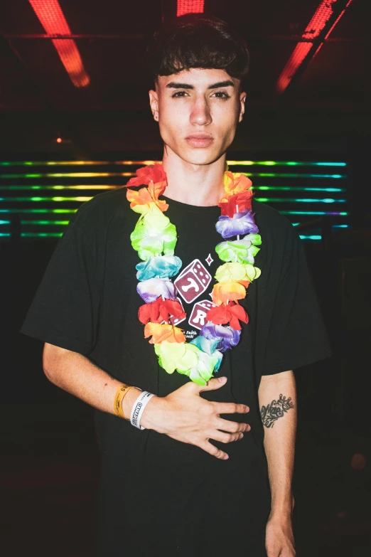 a young man wearing hawaiian flowers and standing