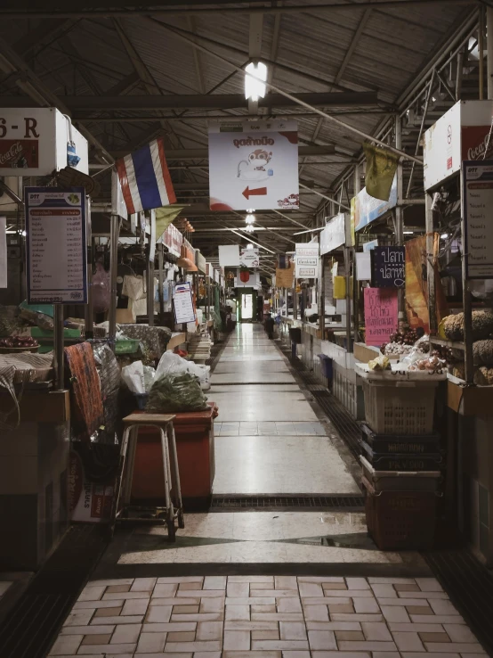 an indoor market with tile floors, flags and signs