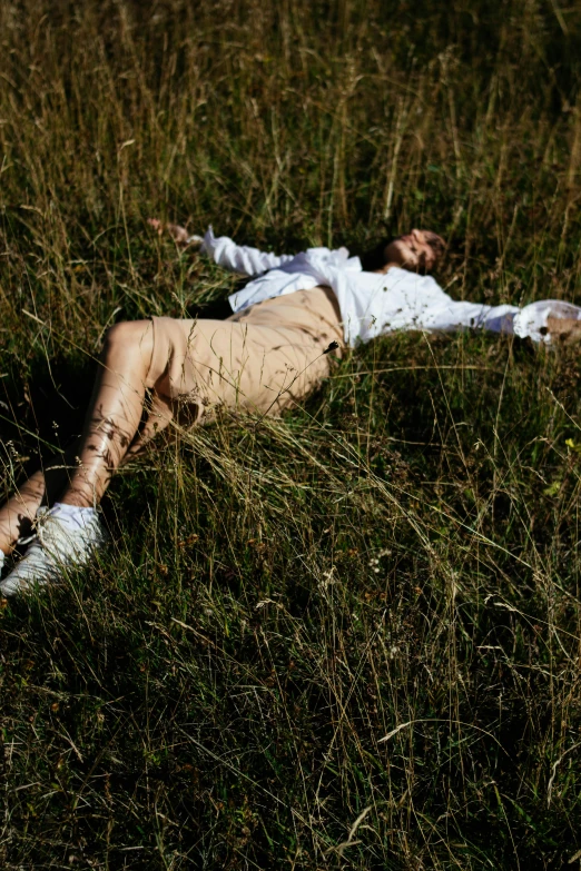 the body of a dead man lying in tall grass