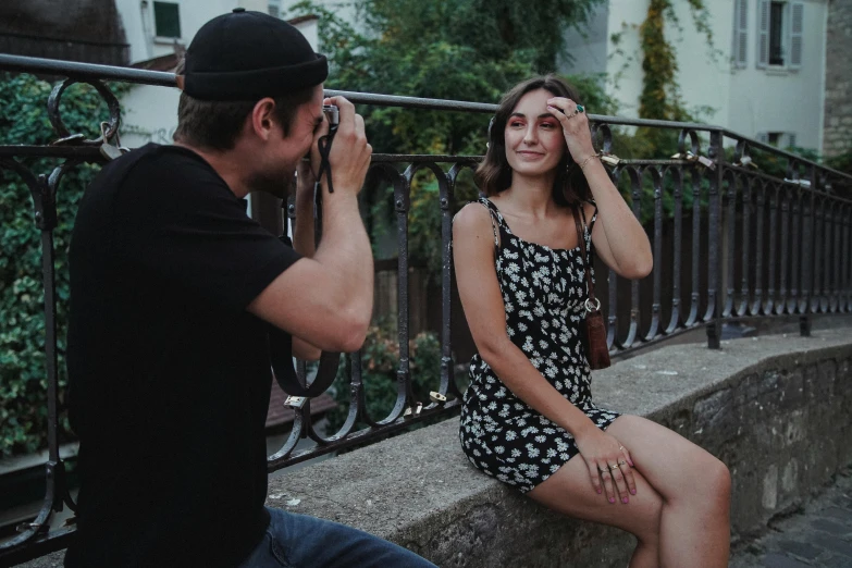 a man pographing a girl on her phone with one hand