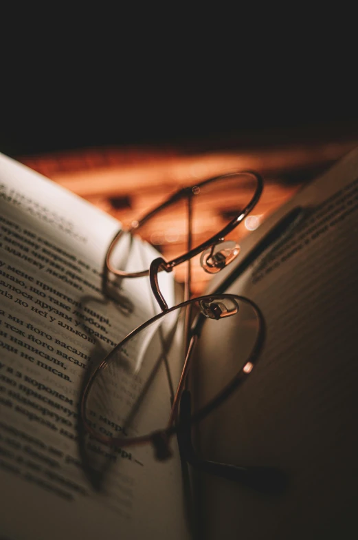 glasses resting on top of an open book