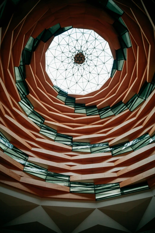 an intricate glass window is reflected in the ceiling