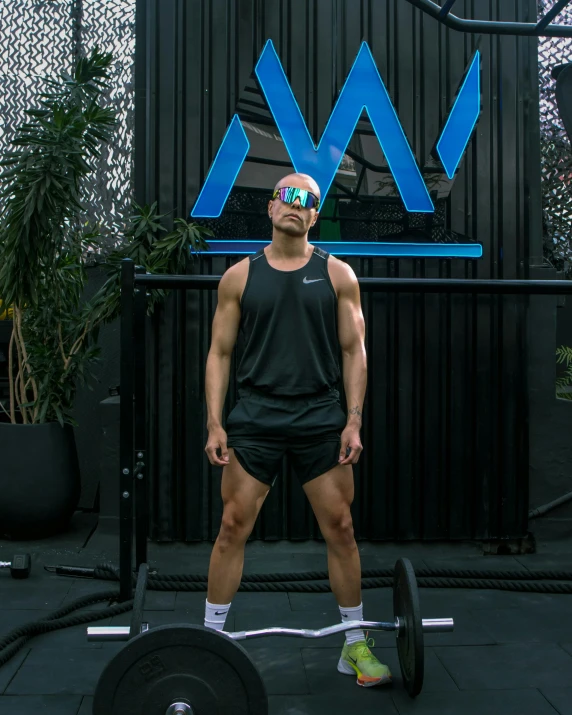 a man is lifting a barbell outside