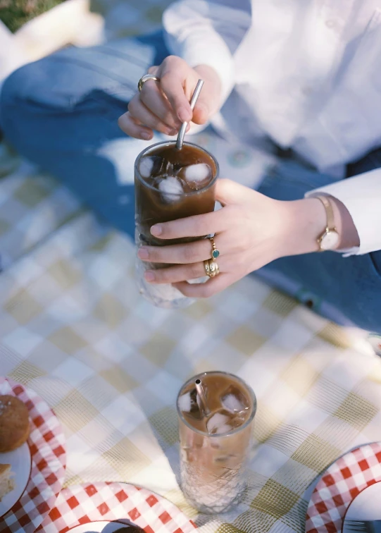 people sitting at table with drinks and sandwiches