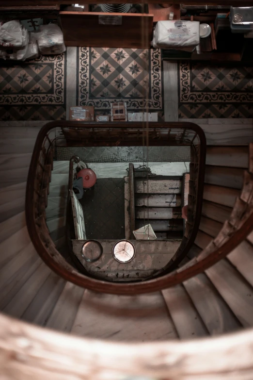 looking down at a spiral staircase in the middle of a building