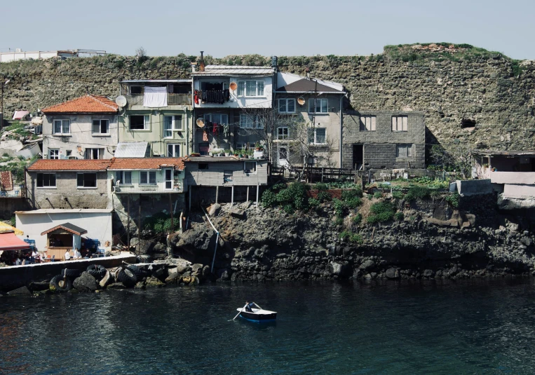 a boat is on the water near some old buildings