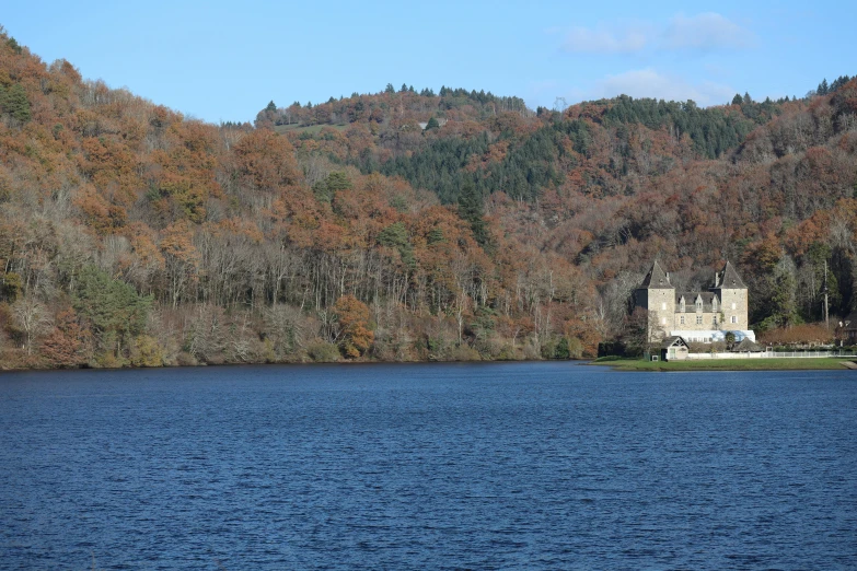 a castle on top of a lake in the mountains