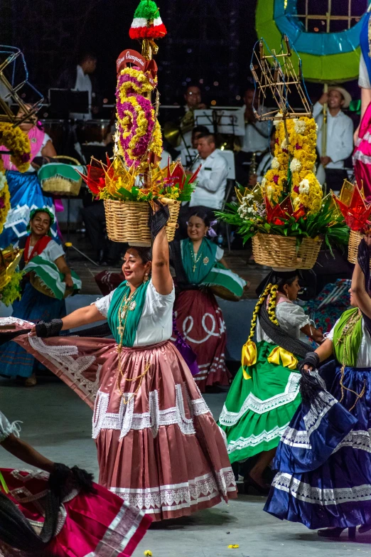 women dance around with colorful costumes in an event