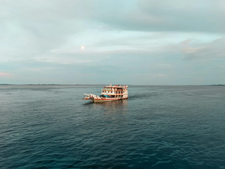 a fishing boat moving along the water in open ocean