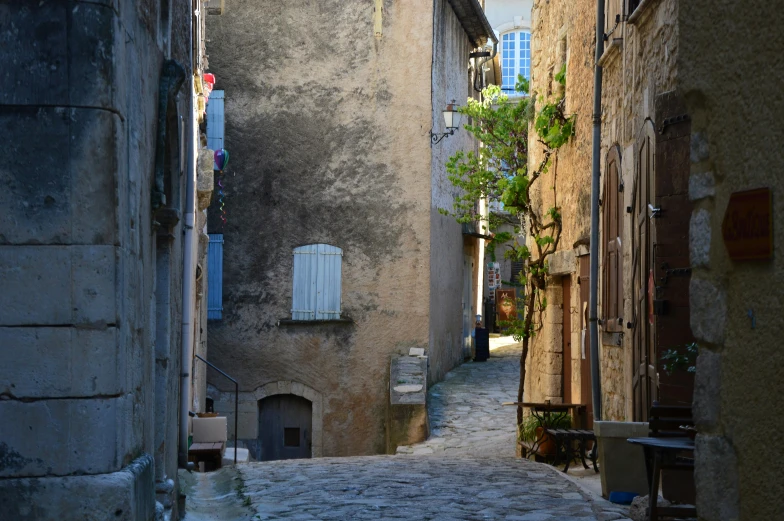 a street lined with old buildings and buildings that have shutters and a small white door