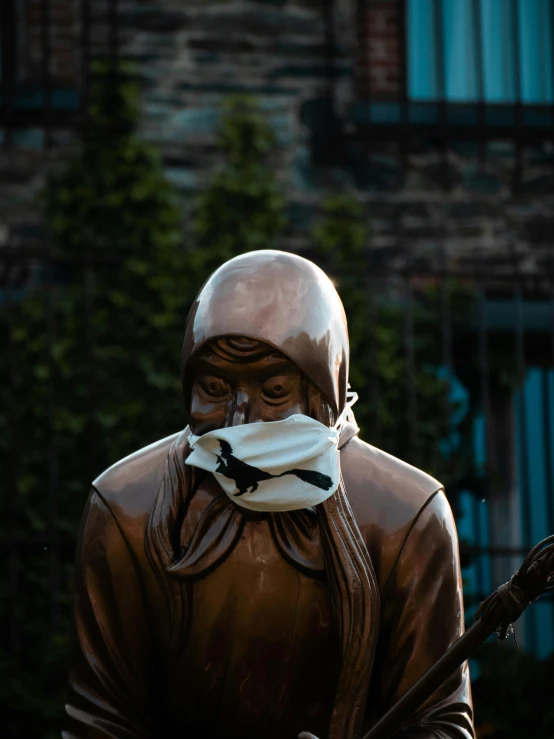 a statue of a person with a white sheet around his mouth