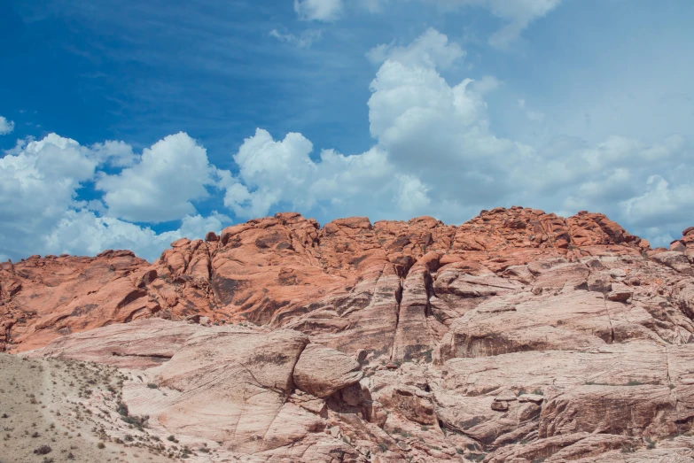 a group of people standing on a rocky mountain range