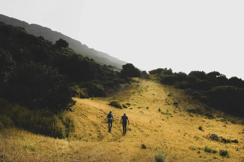 two people in the mountains standing near each other