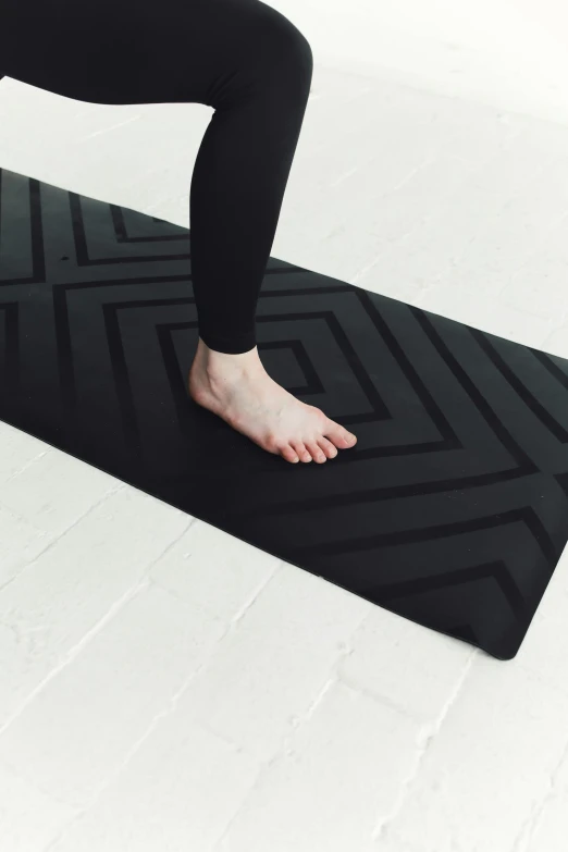 a person in a yoga position on a yoga mat