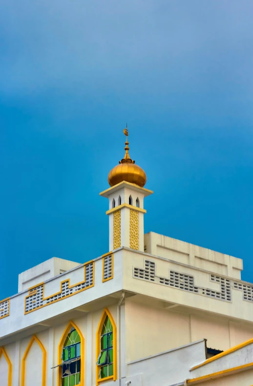 the top of a building has a gold - trimmed dome and yellow - trimmed windows