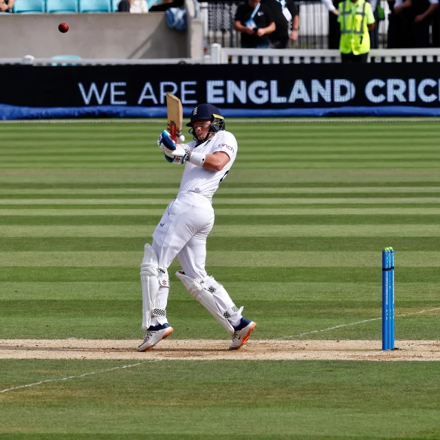 a cricket player is hitting the ball on the field