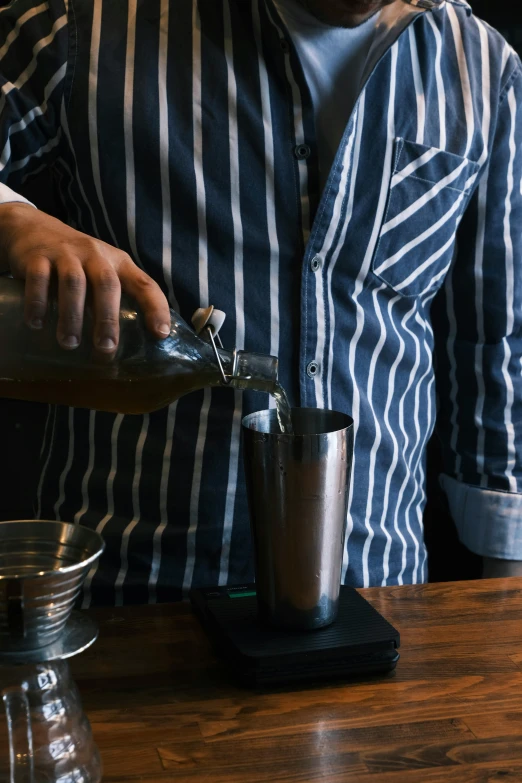 the man is preparing a drink from a bar