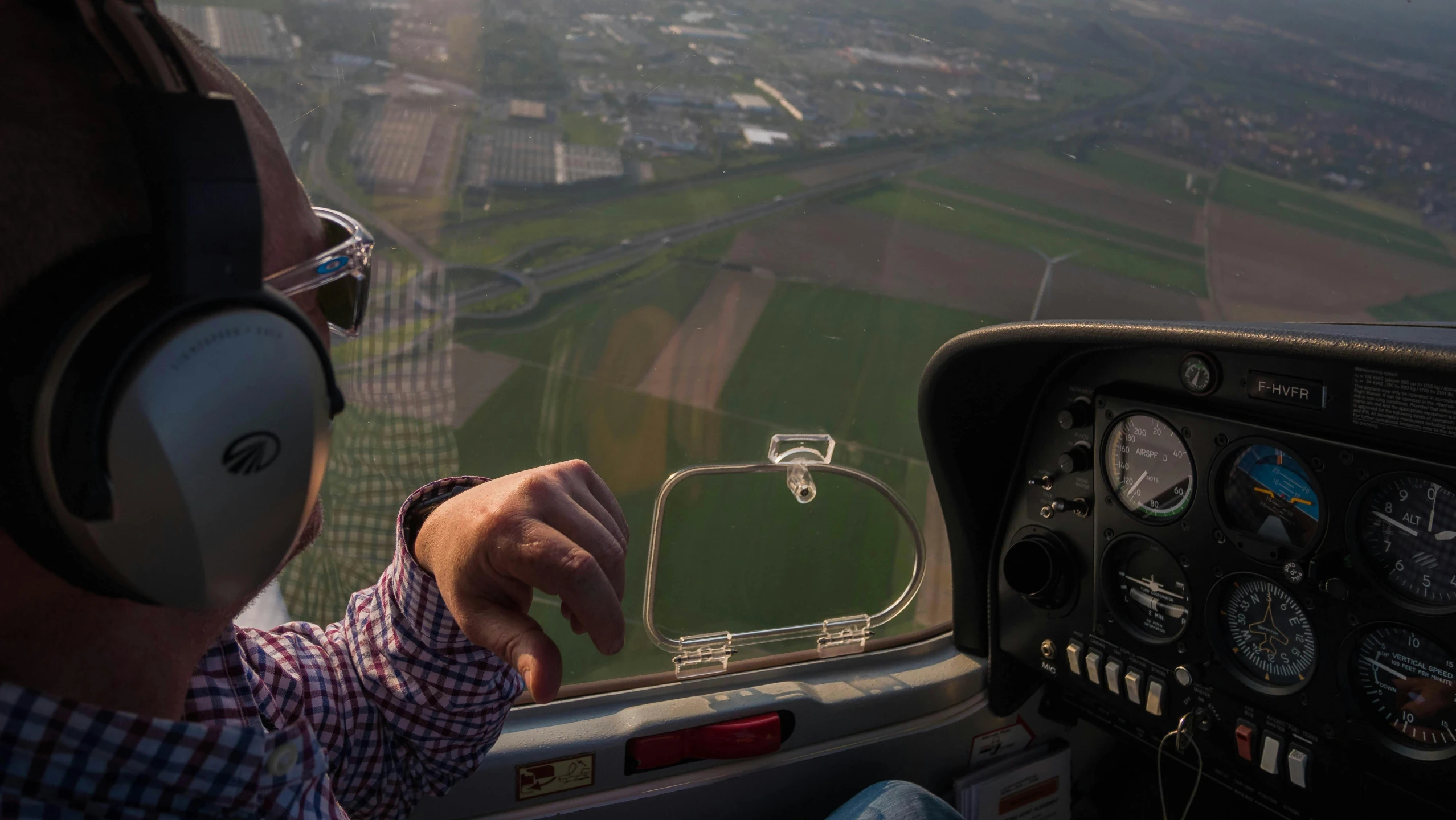 a person wearing headphones is flying in an airplane