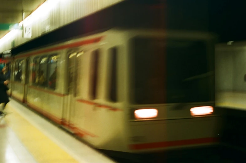 a blurry po of a passenger train on the tracks