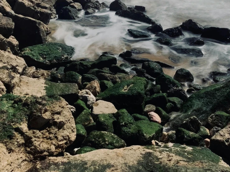 rocky shore near ocean with waves breaking on rocks