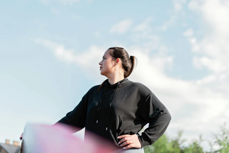 woman in black top holding large kite outdoors