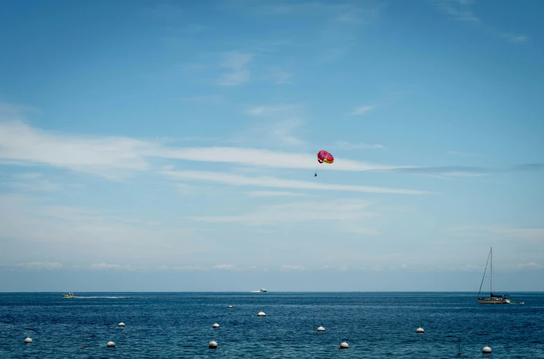 a colorful kite flying over some blue water