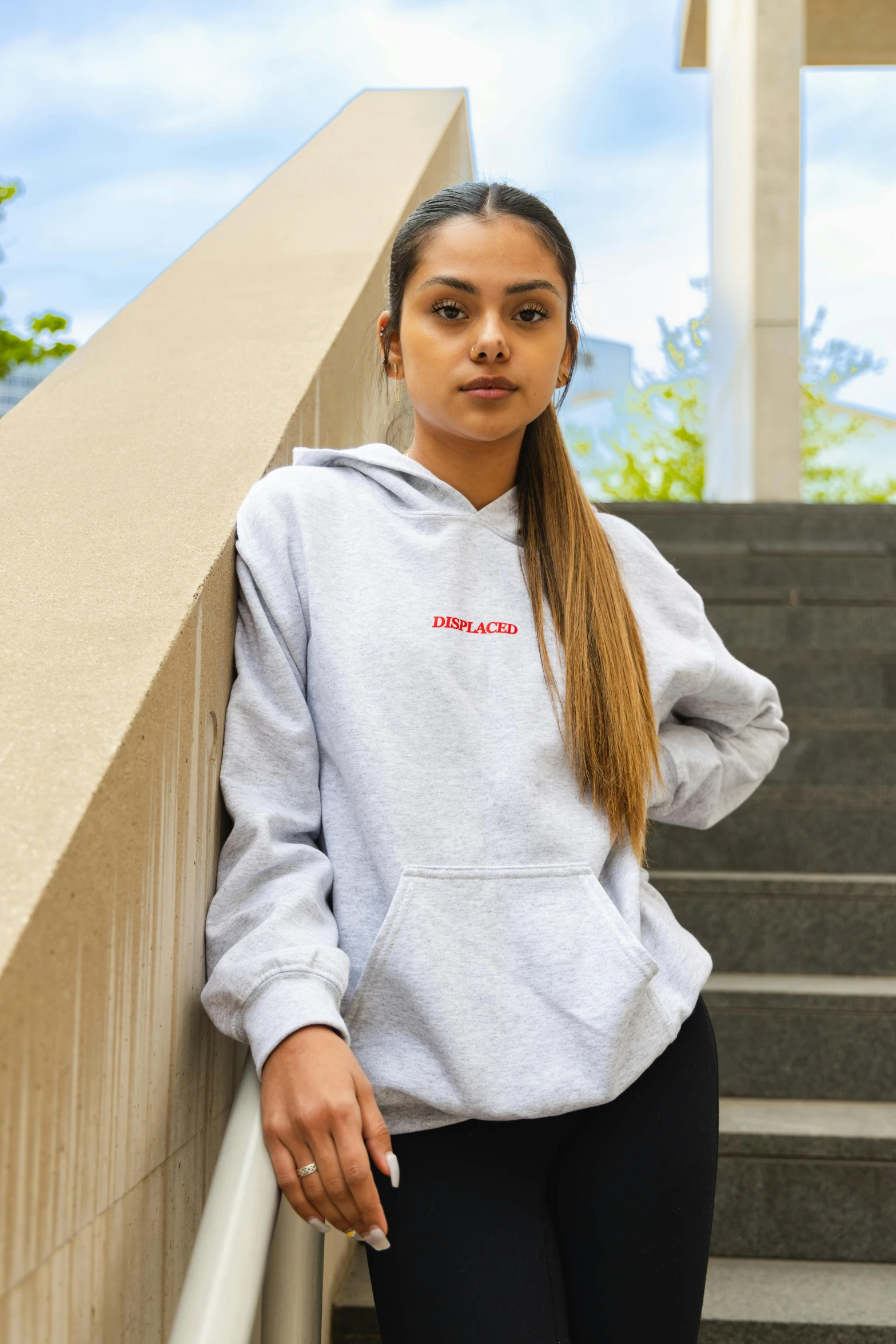 young black woman leaning on the handrail of steps