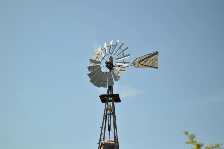 a metal windmill with two antennas attached