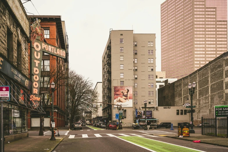 the city street is lined with tall buildings