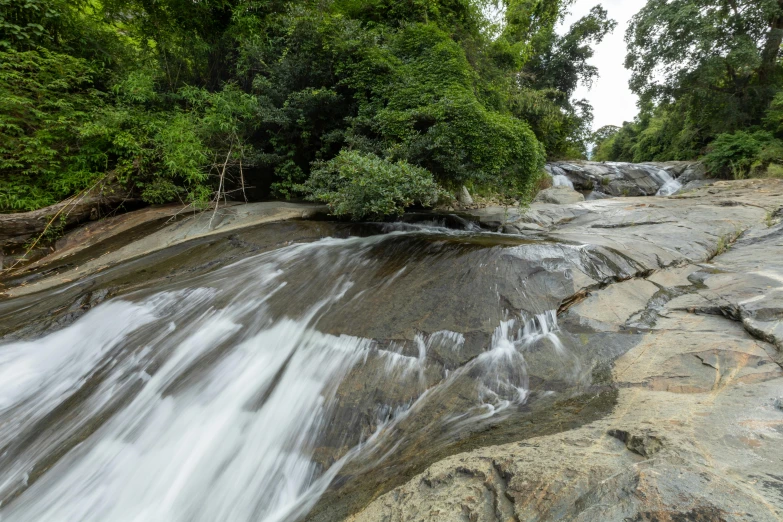 a large waterfall in the middle of rocks