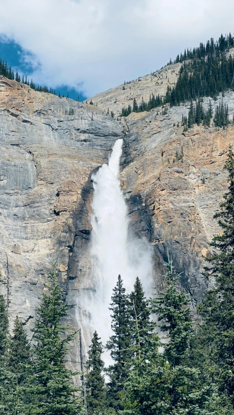 waterfall falling into the river from a cliff