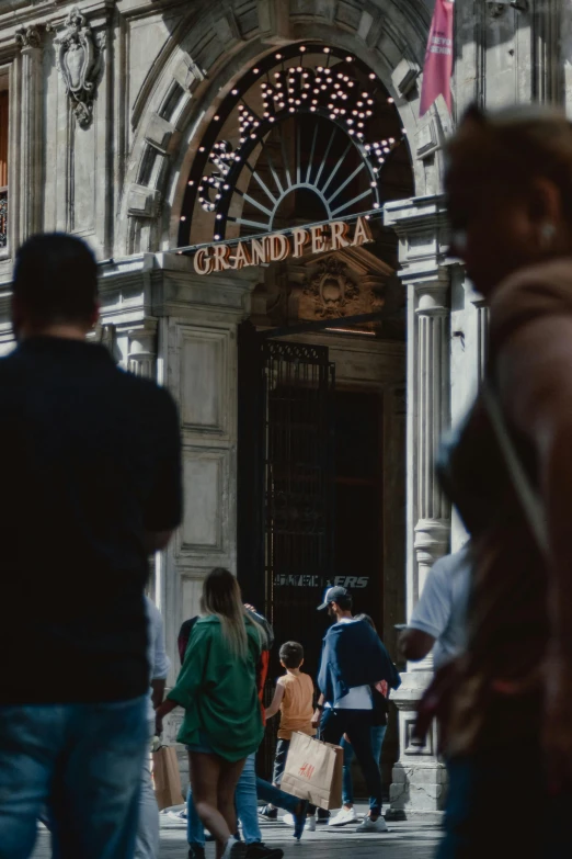 a group of people walking in front of a building