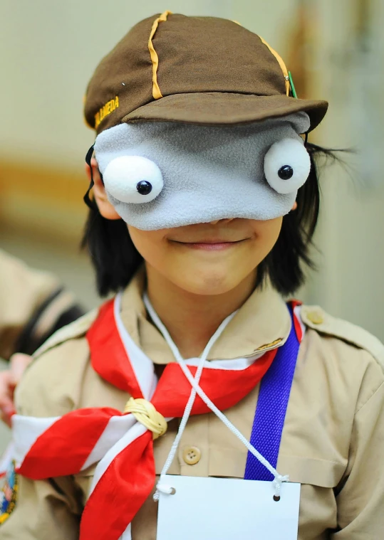 a girl with a hat on her head that has eyes