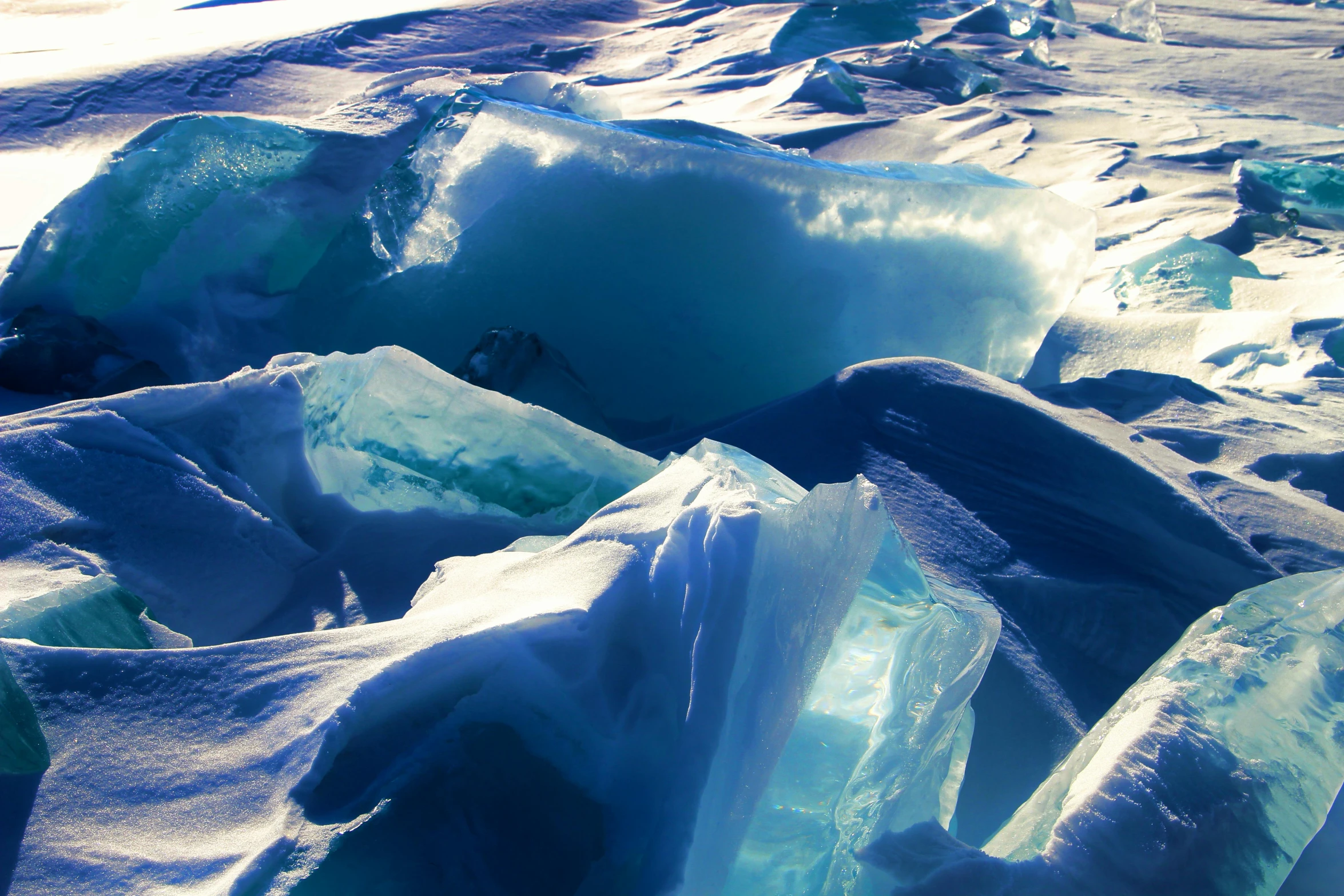 ice crystals lying on the ground and blue ice