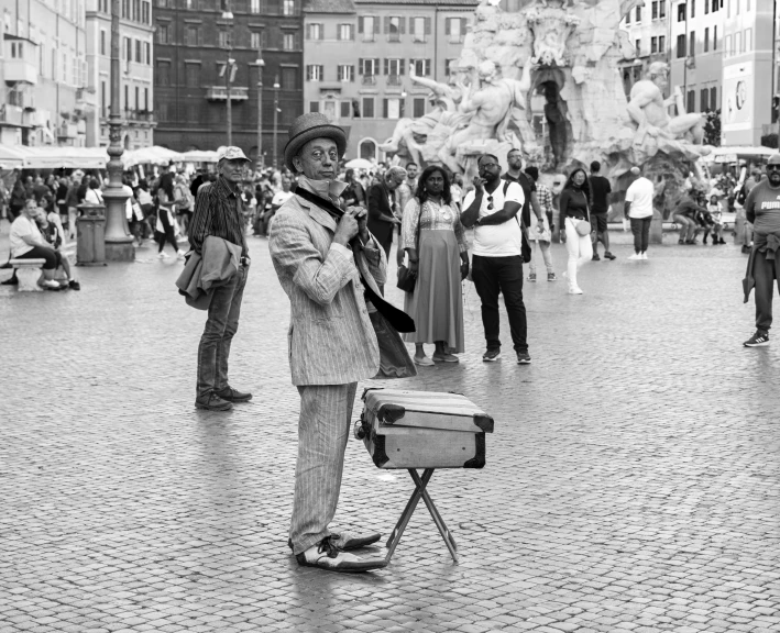 there is a man standing on a small bench and holding an umbrella