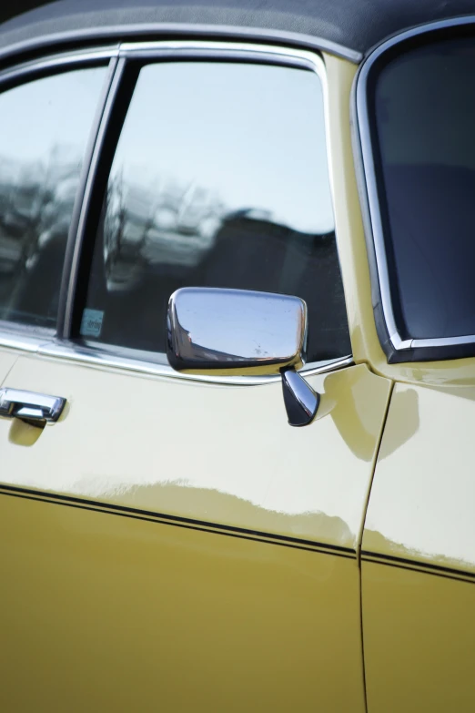 an older car has been left in place with its mirrors off