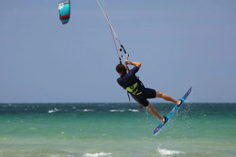 a man riding a kiteboard in the ocean