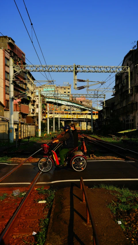 a street and railroad tracks near many buildings