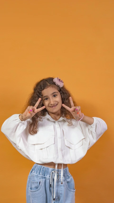 a little girl making the letter i with her hands