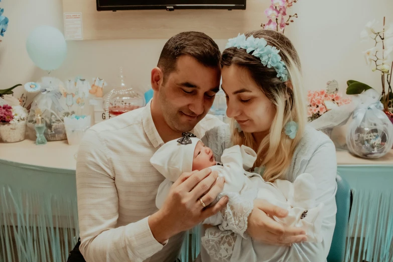 a man and woman are holding a baby