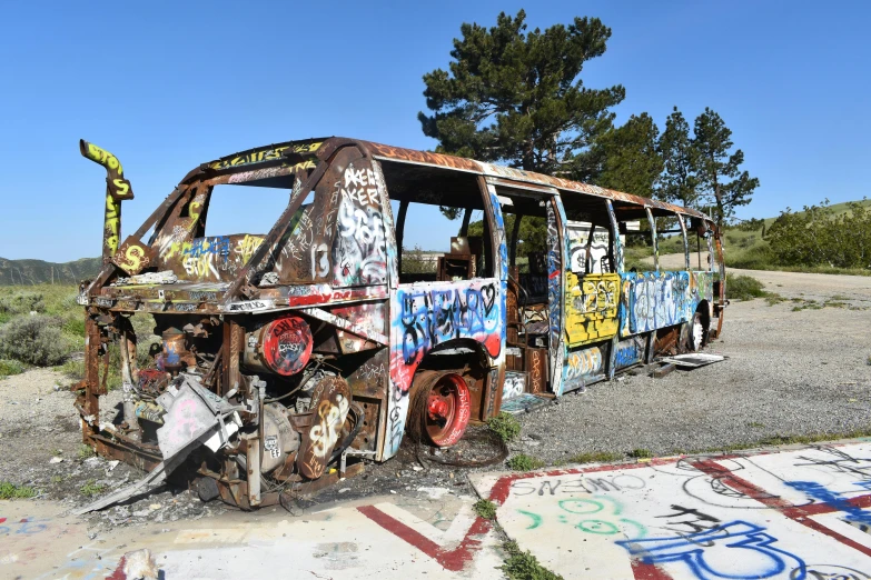 a destroyed bus that has been sitting in a field