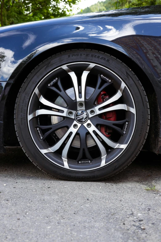 a close up of a black and red wheel on a car