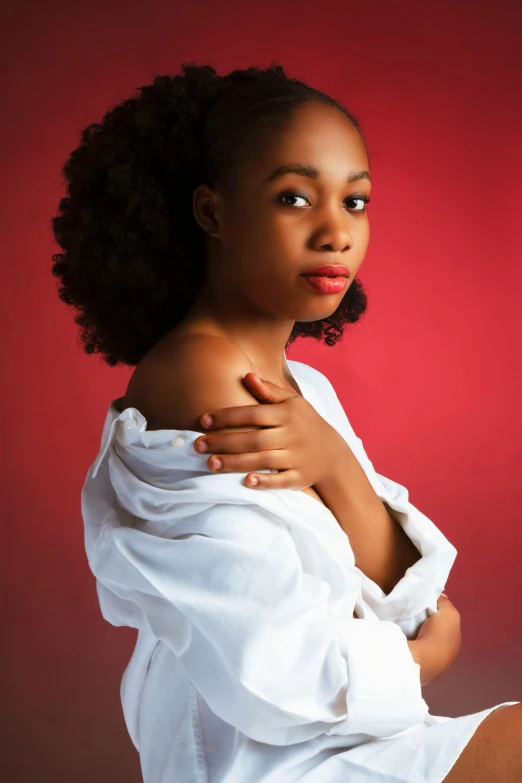 a woman wearing a bathrobe with one hand on her chest